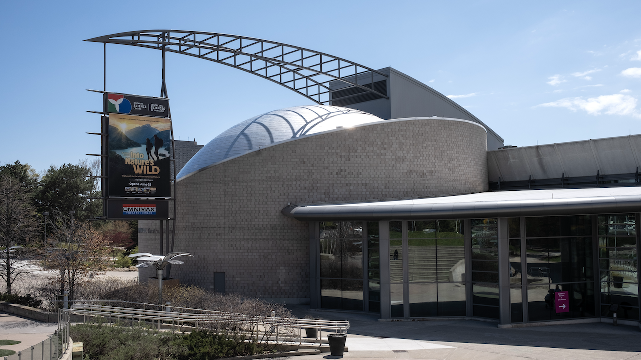 domed concrete building with exhibition sign outside