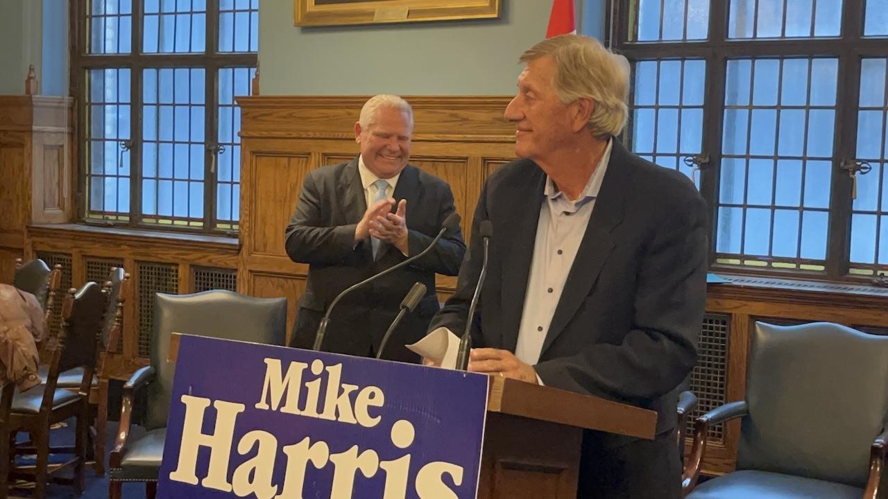 two men in suits behind a podium